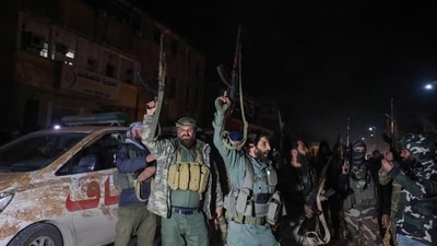 Islamist-led Syrian rebel fighters celebrate in front of the main telecommunications building in the heart of Homs. (AFP) Islamist-led Syrian rebel fighters celebrate in front of the main telecommunications building in the heart of Homs. (AFP)