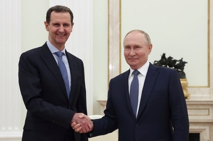 FILE - Syrian President Bashar Assad, left, and Russian President Vladimir Putin shake hands during their meeting in Moscow, (AP)