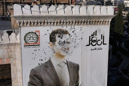 A bullet-riddled portrait of Assad adorning Hama's municipality building after it was defaced following the capture of the city by rebels. (AFP) A bullet-riddled portrait of Assad adorning Hama's municipality building after it was defaced following the capture of the city by rebels. (AFP)