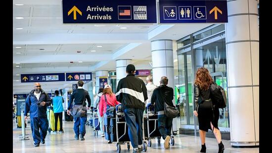 Travellers in the arrivals terminal at Montreal-Pierre Elliott Trudeau International Airport (YUL) in Montreal, Quebec, Canada. (Bloomberg)