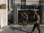 Rebel fighters walk in front of Syrian Central Bank, after rebels seized the capital and ousted President Bashar al-Assad, in Damascus, Syria, December 9, 2024.