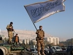 An anti-government fighter waves an Islamic flag from atop a tank in Damascus on December 9, 2024. Syrians flocked to the main square of the capital city to celebrate the fall of president Bashar al-Assad.