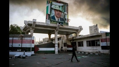 A defaced portrait of late Syrian president Hafez al-Assad stands above a ransacked government security facility, in Damascus, on December 8, 2024.. (Photo by Rami al SAYED / AFP) (AFP) A defaced portrait of late Syrian president Hafez al-Assad stands above a ransacked government security facility, in Damascus, on December 8, 2024.. (Photo by Rami al SAYED / AFP) (AFP)