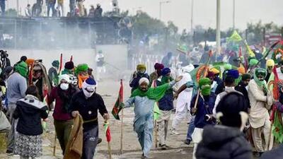 Farmers cover their faces with cloth as police fire tear gas during a protest at the Punjab-Haryana state Shambhu border in Punjab on December 8 (AFP) Farmers cover their faces with cloth as police fire tear gas during a protest at the Punjab-Haryana state Shambhu border in Punjab on December 8 (AFP)
