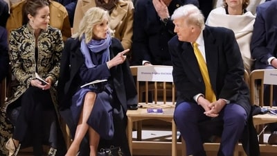 Jill Biden and Trump were waiting for French First Lady Brigitte Macron to assume the seat between them. (Reuters) Jill Biden and Trump were waiting for French First Lady Brigitte Macron to assume the seat between them. (Reuters)