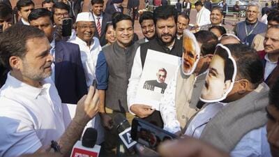 New Delhi: Leader of Opposition Rahul Gandhi interviews Congress MPs Manickam Tagore and Saptagiri Sankar Ulaka, wearing face masks of Prime Minister Narendra Modi and Adani Group chairman Gautam Adani, at a protest during the Winter session of Parliament on Monday. (PTI) New Delhi: Leader of Opposition Rahul Gandhi interviews Congress MPs Manickam Tagore and Saptagiri Sankar Ulaka, wearing face masks of Prime Minister Narendra Modi and Adani Group chairman Gautam Adani, at a protest during the Winter session of Parliament on Monday. (PTI)