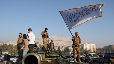An anti-government fighter waves an Islamic flag from atop a tank in Damascus on December 9, 2024. Syrians flocked to the main square of the capital city to celebrate the fall of president Bashar al-Assad. (AFP) An anti-government fighter waves an Islamic flag from atop a tank in Damascus on December 9, 2024. Syrians flocked to the main square of the capital city to celebrate the fall of president Bashar al-Assad. (AFP)