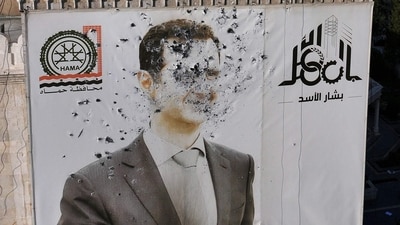 A bullet-riddled portrait of Al-Assad adorning Hama's municipality building after it was defaced following the capture of the city by rebels. (AFP) A bullet-riddled portrait of Al-Assad adorning Hama's municipality building after it was defaced following the capture of the city by rebels. (AFP)