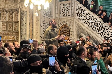 Syrian rebel chief Abu Mohammed al-Golani speaks to a crowd at Ummayad Mosque in Damascus after Assad's fall. (Reuters)