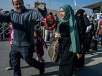 Syrian families arrive to cross into Syria from Turkey at the Cilvegozu border gate, near the town of Antakya, southern Turkey
