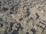 An aerial photo shows the destroyed buildings at the Yarmouk camp for Palestinian refugees in southern Damascus on December 10, 2024. The fall of president Bashar al-Assad has put Syria at a crossroads, after nearly 14 years of civil war sparked by his deadly crackdown on democracy protests. (Photo by Mohammed AL-RIFAI / AFP)