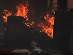 A structure burns as the Franklin Fire grows in Malibu, California, on December 10, 2024. A wind-fanned wildfire quickly spread early on Tuesday in Malibu, threatening homes and businesses in the coastal California community where many Hollywood elites reside. 