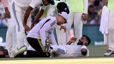 Indian bowler Jasprit Bumrah (R) receives treatment to his leg on the second day of the second Test cricket match between Australia and India at the Adelaide Oval in Adelaide on December 7, (AFP) Indian bowler Jasprit Bumrah (R) receives treatment to his leg on the second day of the second Test cricket match between Australia and India at the Adelaide Oval in Adelaide on December 7, (AFP)