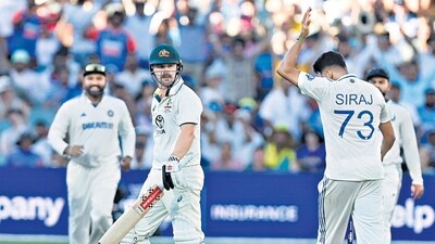 India's Mohammed Siraj, right, celebrates after the dismissal of Australia's Travis Head, centre, during the day two of the day-night Test (HT_PRINT) India's Mohammed Siraj, right, celebrates after the dismissal of Australia's Travis Head, centre, during the day two of the day-night Test (HT_PRINT)
