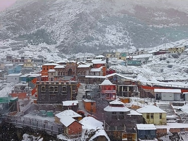 Chamoli: Badrinath Dham receives the first snowfall of the season, in Chamoli district on Monday. (PTI)