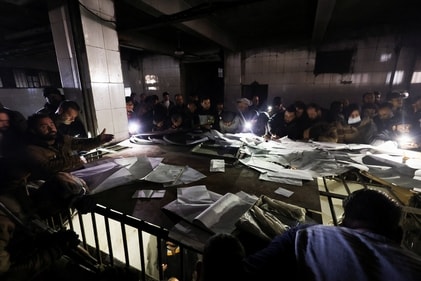 People search through papers as they join members of the Syrian civil defence group, known as the White Helmets, to search for prisoners underground at Sednaya prison, after rebels seized the capital and announced that they have ousted President Bashar al-Assad in Sednaya, Syria, December 9, 2024. (REUTERS)