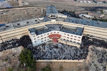 An aerial photo shows people gathering at the Sednaya prison in Damascus on December 9, 2024. (AFP) An aerial photo shows people gathering at the Sednaya prison in Damascus on December 9, 2024. (AFP)