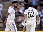 Mohammed Siraj (L) gestures to Travis Head