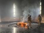 Rebel fighters stand next to the burning gravesite of Syria's late president Hafez al-Assad at his mausoleum in the family's ancestral village of Qardaha in the western Latakia province. Rebel fighters stand next to the burning gravesite of Syria's late president Hafez al-Assad at his mausoleum in the family's ancestral village of Qardaha in the western Latakia province.