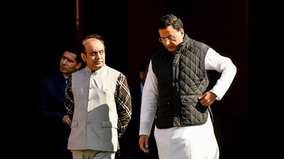Congress MP Randeep Surjewala with BJP MP Sudhanshu Trivedi during the winter session at Parliament in New Delhi on Wednesday. (ANI)