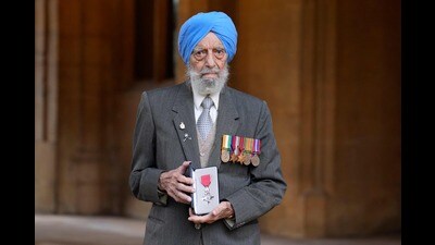 Former soldier Havildar Major Rajindar Dhatt poses with his medal after being made an Honorary Member of the Order of the British Empire (MBE) at an Investiture ceremony at Windsor Castle, west of London. (AFP)
