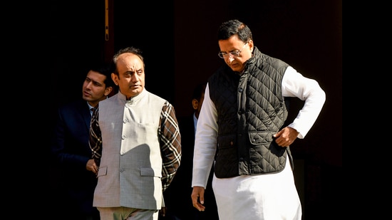 Congress MP Randeep Surjewala with BJP MP Sudhanshu Trivedi during the winter session at Parliament in New Delhi on Wednesday. (ANI)