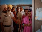 Voters stand in queues to cast their votes outside a booth at a polling station during the last phase of Lok Sabha 2024 elections.