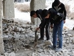 Kids search and inspect bones amidst rubbles after what residents and rights groups described as years of killings there under the rule of Syria's Bashar al-Assad.