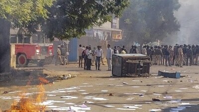 Parbhani: A structure set on fire during protests which continued for the second day over alleged vandalising of a replica of the Indian Constitution, in Parbhani, Maharashtra, Wednesday, Dec. 11, 2024. The stone replica of the Constitution outside Parbhani railway station, set in front of a statue of Dr B R Ambedkar, was found to have been damaged on Tuesday, sparking protests. (PTI Photo) (PTI12_11_2024_000224B) (PTI)