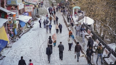 People walk on a snow covered road after fresh snowfall in Shimla. (PTI) People walk on a snow covered road after fresh snowfall in Shimla. (PTI)