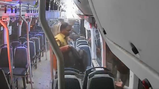 The BEST bus driver, Sanjay More, jumped out of a broken window with two backpacks. (Screengrab/X/@rahulpawar185)