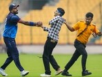 Bengaluru: Baroda's Hardik Pandya, left, reacts as a pitch invader being taken off field by ground staff during the first semi-final T20 cricket match of the Syed Mushtaq Ali Trophy