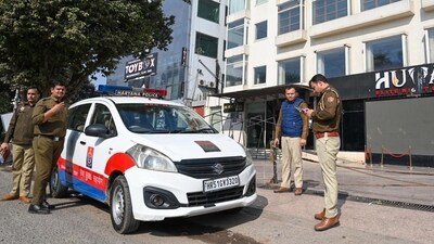 A team of the National Investigation Agency (NIA) and Gurugram Police at the spot where a crude bomb was thrown outside a club in Sector 29 early on Tuesday morning. (HT Photo) A team of the National Investigation Agency (NIA) and Gurugram Police at the spot where a crude bomb was thrown outside a club in Sector 29 early on Tuesday morning. (HT Photo)