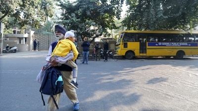 A student with his guardian returns from GD Goenka Public School, Paschim Vihar after the school received bomb threat. (PTI) A student with his guardian returns from GD Goenka Public School, Paschim Vihar after the school received bomb threat. (PTI)