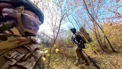 In this photo taken from video released by the Russian Defense Ministry Press Service on Tuesday, Nov. 26, 2024, a couple of Russian Army snipers walk changing their position while fighting with Ukrainian Armed forces at an undisclosed location in Ukraine. (AP)