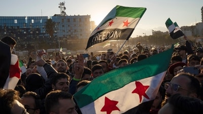 Syrians wave "revolutionary" Syrian flags during a celebratory demonstration following the first Friday prayers since Bashar Assad's ouster, in Damascus' central square, Syria, Friday, Dec. 13, 2024. (AP) Syrians wave "revolutionary" Syrian flags during a celebratory demonstration following the first Friday prayers since Bashar Assad's ouster, in Damascus' central square, Syria, Friday, Dec. 13, 2024. (AP)