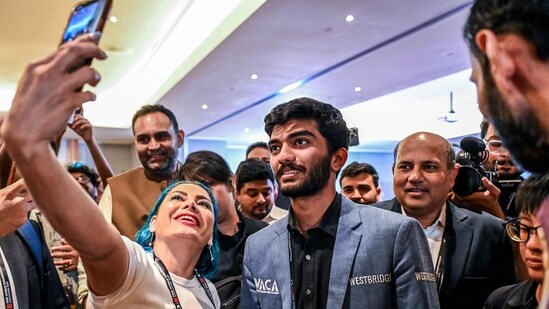 A fan takes a selfie with India's grandmaster Gukesh Dommaraju (C) after his win against China's chess grandmaster Ding Liren (AFP)