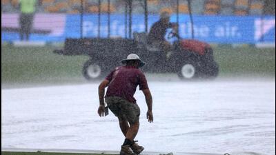 Ground staff cover the pitch at the Gabba as rain stopped the first day’s play in the third Test between Australia and India in Brisbane on Saturday. (AFP) Ground staff cover the pitch at the Gabba as rain stopped the first day’s play in the third Test between Australia and India in Brisbane on Saturday. (AFP)