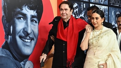 Bollywood actor Randhir Kapoor (L) poses for a photograph with his daughter, actor Karishma Kapoor, during an event marking the 100th birth anniversary of legendary Indian actor and filmmaker Raj Kapoor in Mumbai on December 13. Karisma wore an ivory saree with delicate embroidery for the occasion. (AFP)