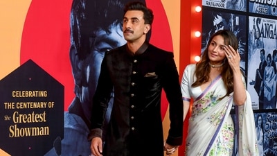 Alia Bhatt wore a classic white saree with an intricate floral print. Paying homage to the showman, Raj Kapoor, who loved the colour white, Alia chose an elegant Sabyasachi saree. Alia's husband, actor Ranbir Kapoor, who is Raj Kapoor's grandson, looked dapper in black. (PTI)
