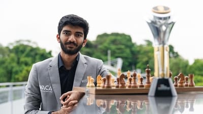 India's D Gukesh poses for photographs with the FIDE World Chess Championship 2024 trophy, in Singapore (PTI)