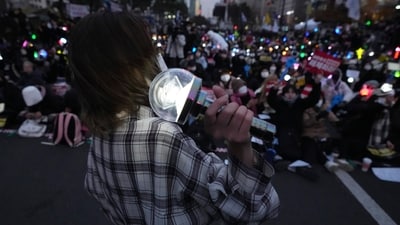 People gathered in front of the National Assembly in Seoul. They all held a wide variety of K-pop lights. (AP Photo/Lee Jin-man) People gathered in front of the National Assembly in Seoul. They all held a wide variety of K-pop lights. (AP Photo/Lee Jin-man)