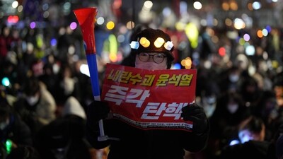 Apart from light sticks, they also carried placards in the rally, demanding the impeachment. (AP Photo/Lee Jin-man) Apart from light sticks, they also carried placards in the rally, demanding the impeachment. (AP Photo/Lee Jin-man)