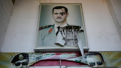 A torn poster shows ousted Syrian President Bashar Assad at the entrance of the notorious security detention centre called Palestine Branch, in Damascus, Syria, Saturday, Dec. 14, 2024. (AP) A torn poster shows ousted Syrian President Bashar Assad at the entrance of the notorious security detention centre called Palestine Branch, in Damascus, Syria, Saturday, Dec. 14, 2024. (AP)