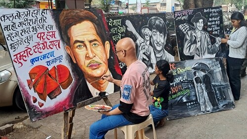 An artist of the Gurukul School of Arts pays tribute to Bollywood veteran actor Raj Kapoor through painting on his 100th Birth Anniversary, in Mumbai on Friday. (ANI Photo) (Deepak Salvi) An artist of the Gurukul School of Arts pays tribute to Bollywood veteran actor Raj Kapoor through painting on his 100th Birth Anniversary, in Mumbai on Friday. (ANI Photo) (Deepak Salvi)