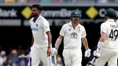 India's Mohammed Siraj (L) reacts after Australia's Travis Head (C) celebrates with teammate Steve Smith after hitting a boundary. (Photo by DAVID GRAY / AFP) (AFP) India's Mohammed Siraj (L) reacts after Australia's Travis Head (C) celebrates with teammate Steve Smith after hitting a boundary. (Photo by DAVID GRAY / AFP) (AFP)