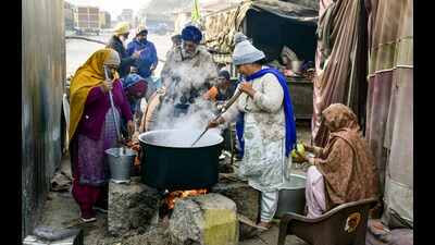 Farmers prepare food at their protest site at Shambhu border in Patiala district on Sunday. (PTI)