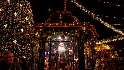 People visit a Christmas fair in Bucharest, Romania, Saturday. (AP) People visit a Christmas fair in Bucharest, Romania, Saturday. (AP)
