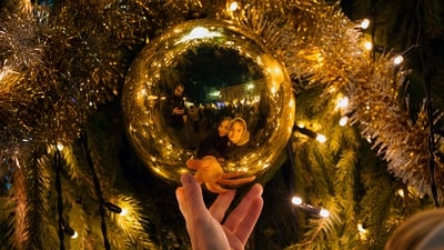 People take pictures of their reflections in the decorations of a Christmas tree, at a Christmas fair in Bucharest, Romania, Saturday. (AP) People take pictures of their reflections in the decorations of a Christmas tree, at a Christmas fair in Bucharest, Romania, Saturday. (AP)