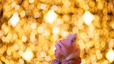 A child looks at light installations while being carried on an adult's shoulders at a Christmas fair in Bucharest, Romania, Saturday. (AP) A child looks at light installations while being carried on an adult's shoulders at a Christmas fair in Bucharest, Romania, Saturday. (AP)